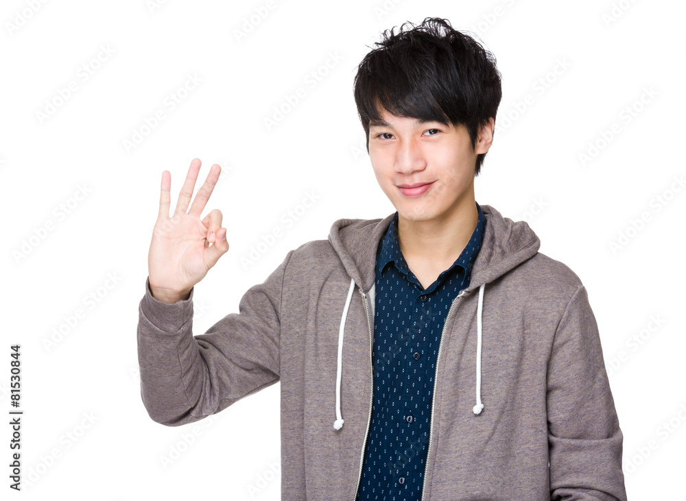 Young asian man showing okay sign Young asian man showing okay sign