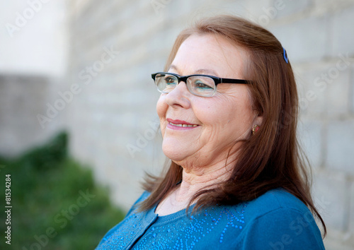 Elderly woman smiling outdoors
