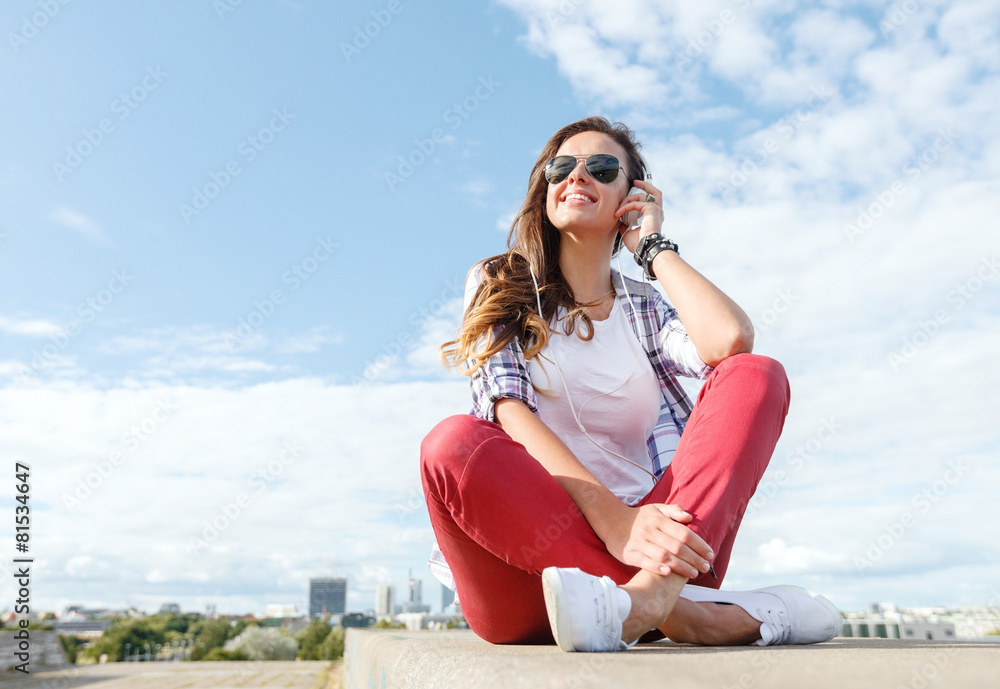 smiling teenage girl in eyeglasses with headphones