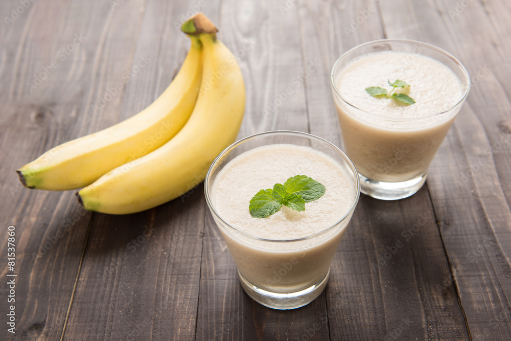 Banana smoothie on wooden table. Banana smoothie on wooden table.
