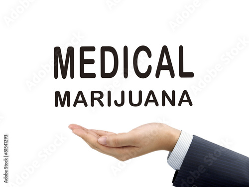 medical marijuana words holding by businessman's hand