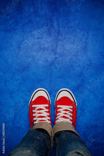 Photography Feet From Above, Teenager in Sneakers Standing on Blue Backgroun