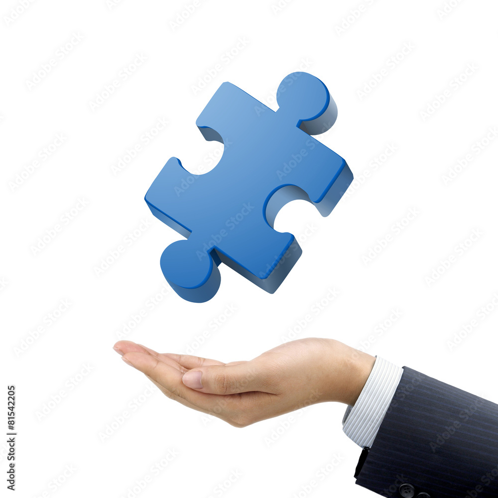 businessman's hand holding jigsaw puzzle piece businessman's hand holding jigsaw puzzle piece
