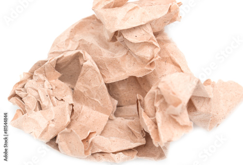 wad of crumpled brown paper on white background