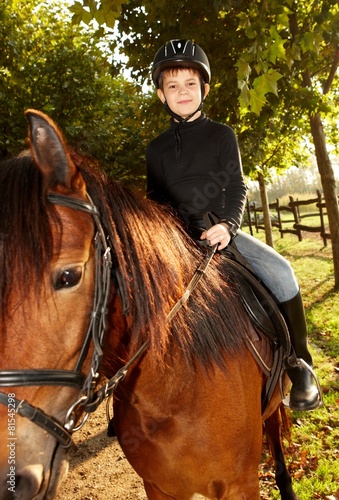 Cute little boy on horseback
