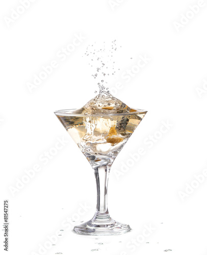 A martini glass on a white background; the water ripples