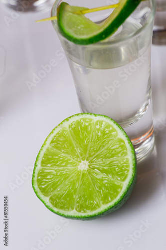 Tequila in glass on white