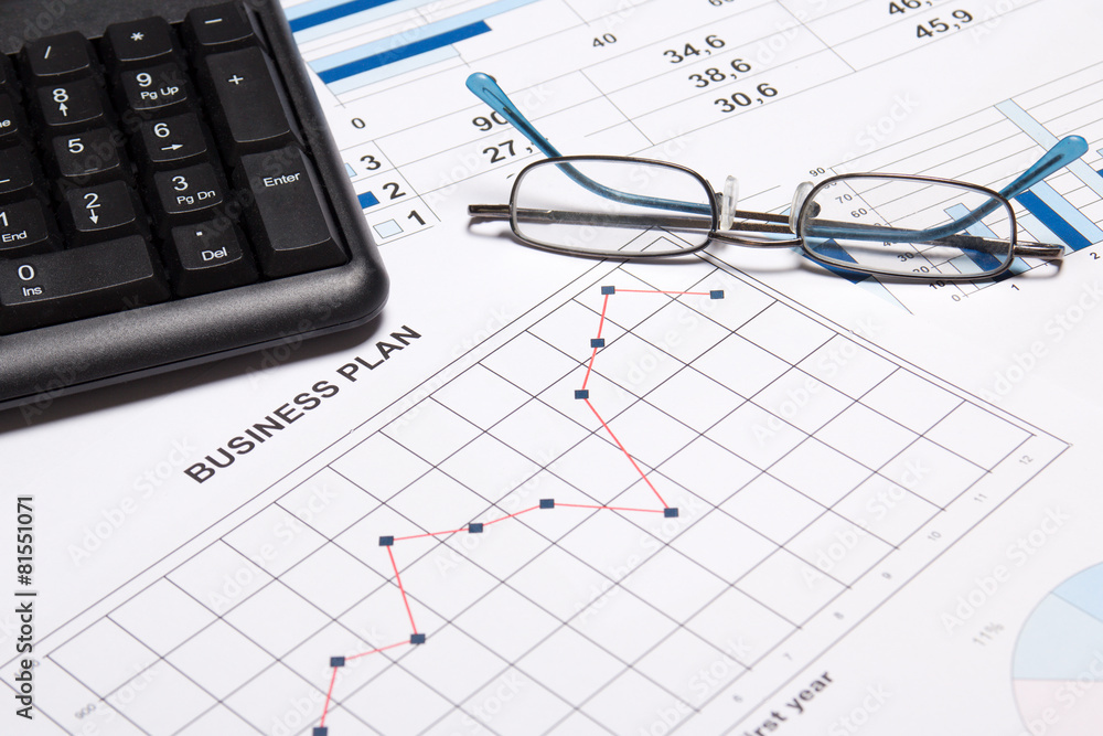 business plan concept - graphs, charts, glasses and keyboard business plan concept - graphs, charts, glasses and keyboard