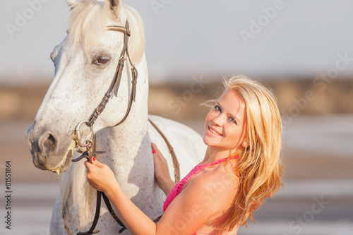 Young happy woman near the horse