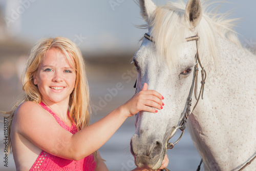 Young happy woman near the horse