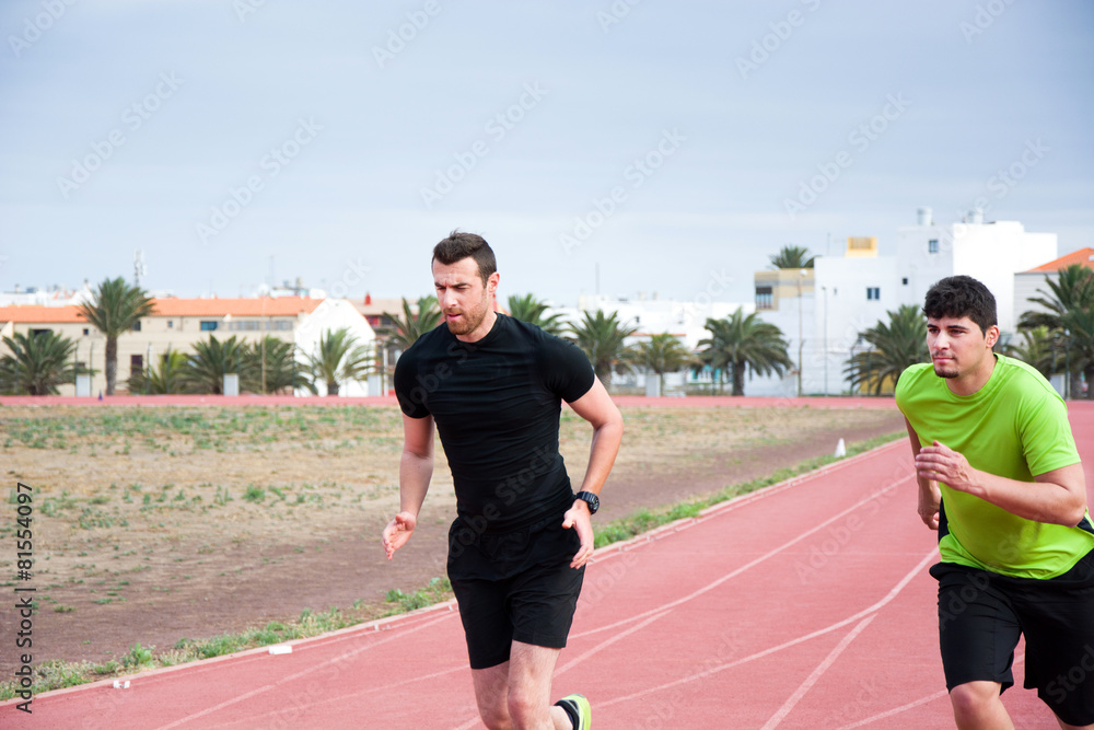 Fototapeta premium Two men running on running track
