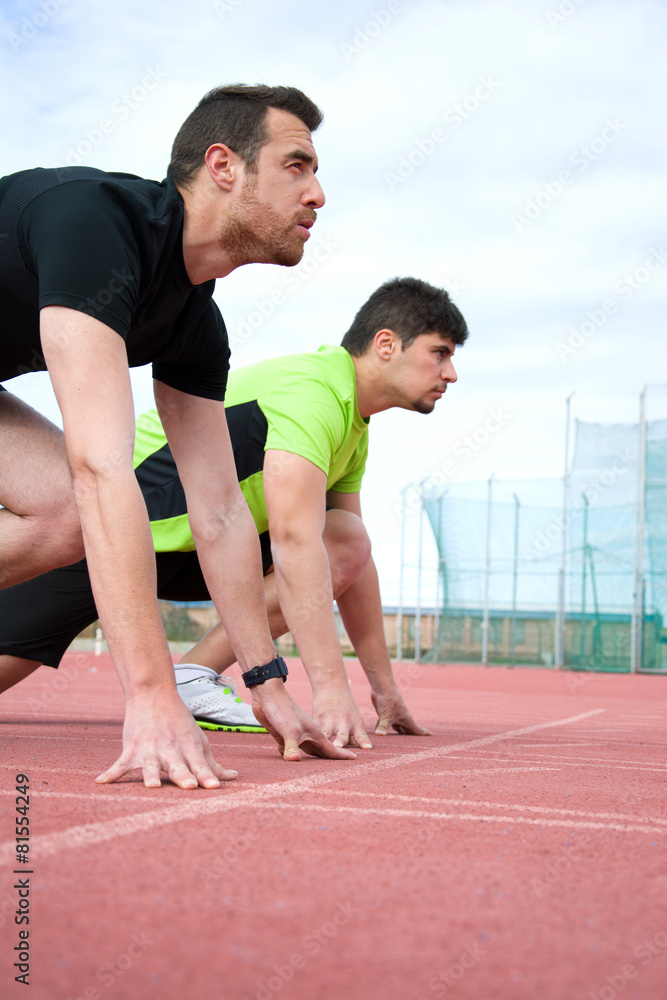 runners at the start of the track runners at the start of the track