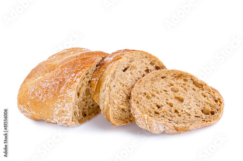 Tasty bread with slices on a white background.