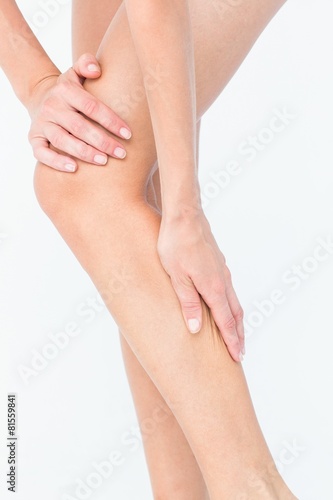 Fototapeta Naklejka Na Ścianę i Meble -  Attractive woman touching her leg