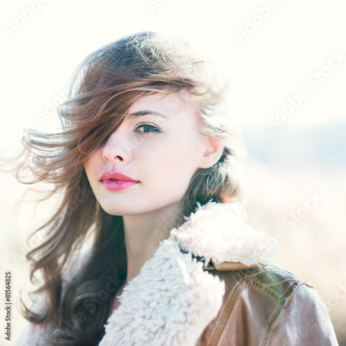Fototapeta Naklejka Na Ścianę i Meble -  portrait of a beautiful young girl with red lips on a sunny day