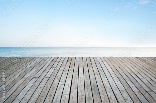 Fototapeta Old vertical striped wooden terrace with sky sea