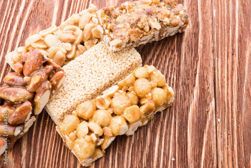 Peanut brittle sweet hard on wooden table Peanut brittle sweet hard on wooden table