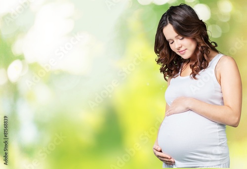 Adorable. Portrait of adorable pregnant woman in white