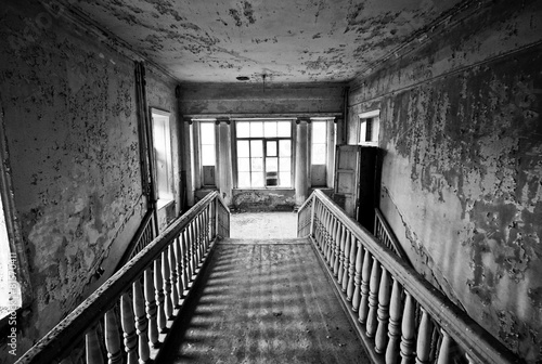 Fototapeta Naklejka Na Ścianę i Meble -  Black and white staircase in the abandoned estate