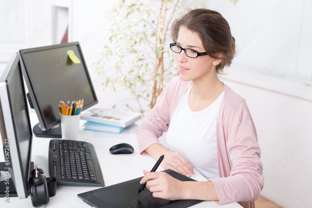 Pc. Side view of a casual male photo editor using graphics Pc. Side view of a casual male photo editor using graphics