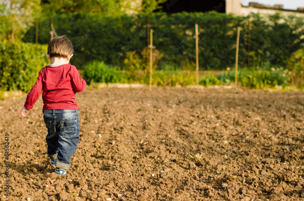 Child in italian rural courtyard