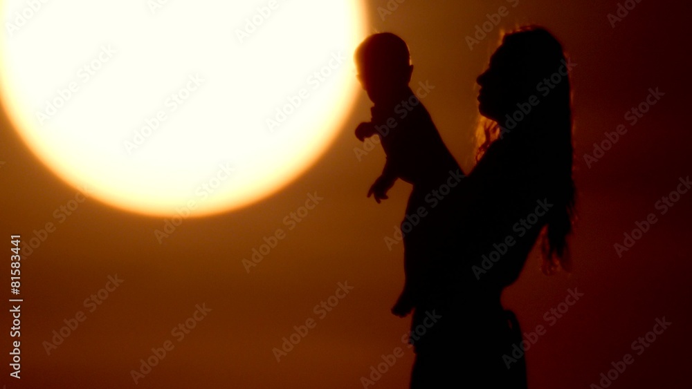 happy mother and little daughter play at sunset happy mother and little daughter play at sunset