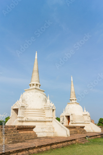 two white stupa under sunlight with sky background