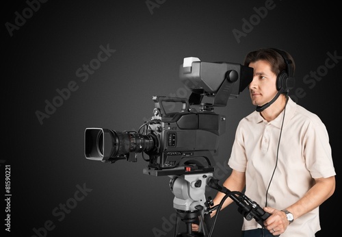 Film. Professional cameraman with headphones with HD camcorder