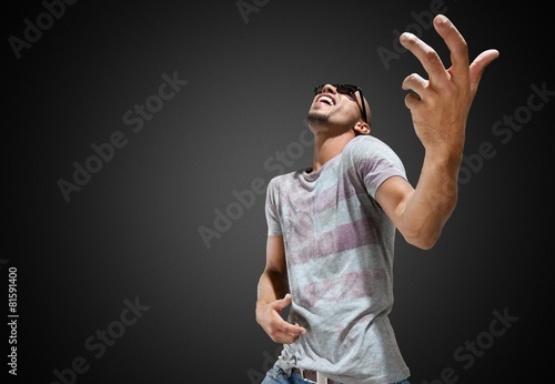 Men. Young man playing air guitar photo