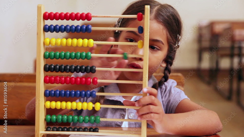 Cute pupil learning maths with an abacus