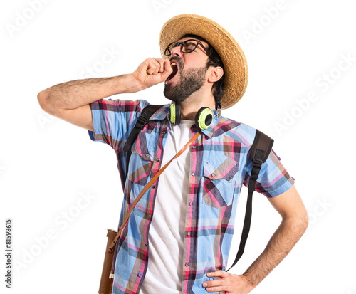 Tourist yawning over white background