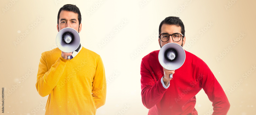 Twin brothers shouting by megaphone