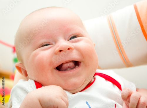 Funny laughing newborn european boy on a grandma hands