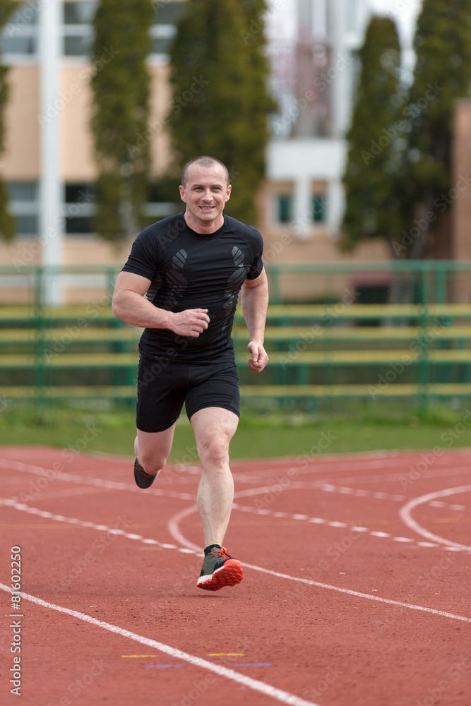 healthy man run on athletics race sport track and representing c