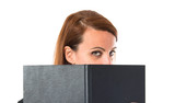 Business woman covering her face with a book