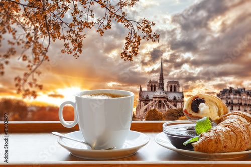 Canvas Print Notre Dame cathedral with coffee and croissants in Paris, France