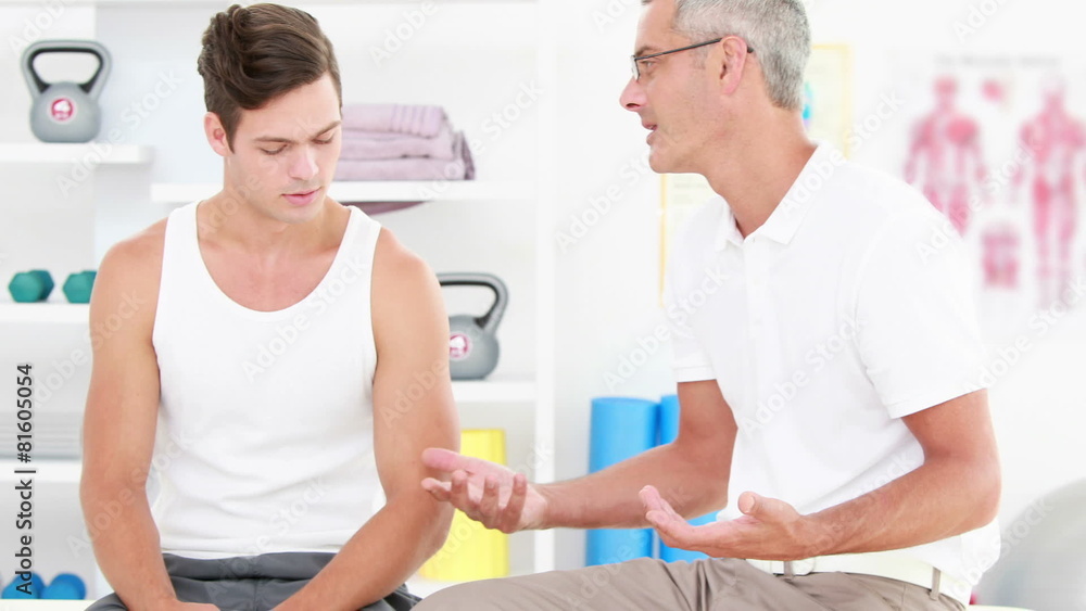Physiotherapist talking with his patient Physiotherapist talking with his patient