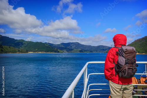 A man looks out over the rail of a cruise ship