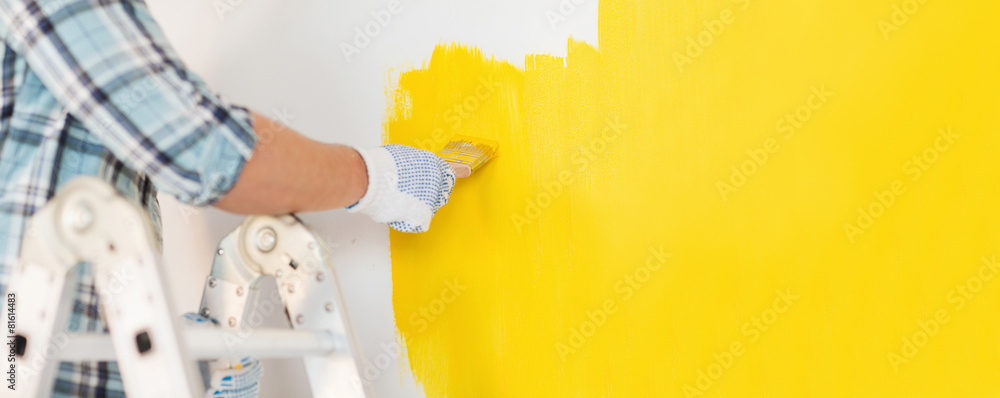 close up of male in gloves painting a wall - obrazy, fototapety, plakaty 