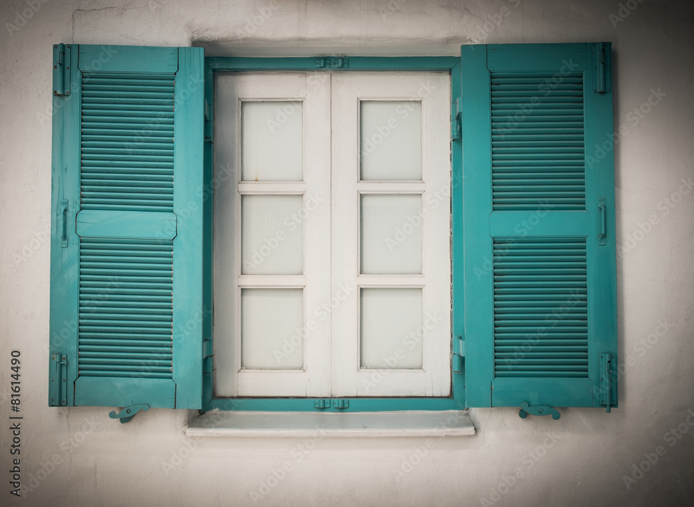 Fototapeta premium Open blue and white wooden window in Greece in retro style