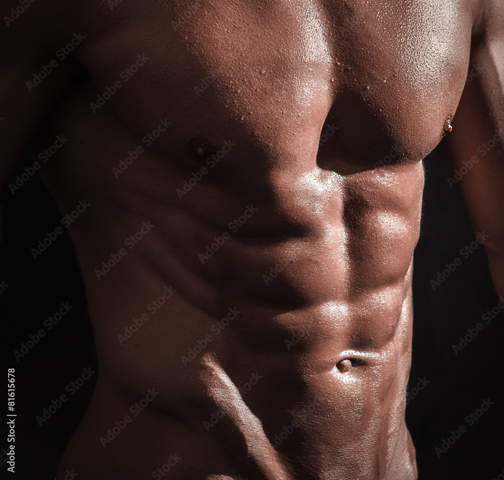 studio shoot of strong athletic man on dark background studio shoot of strong athletic man on dark background