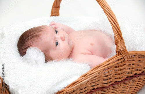 baby boy lying in basket