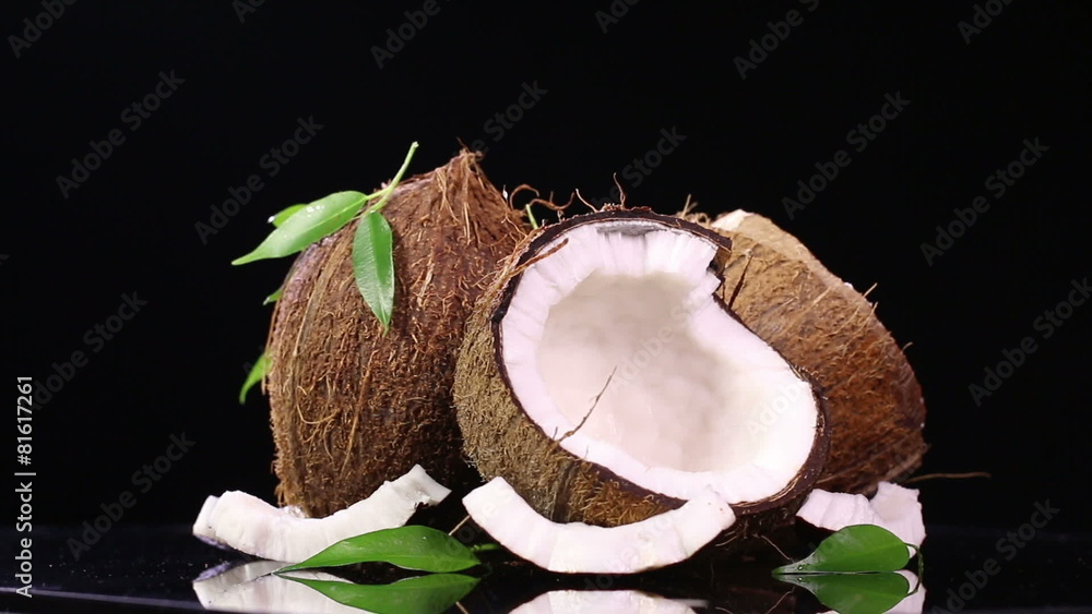 Fresh coconuts on black background in rotation move Fresh coconuts on black background in rotation move