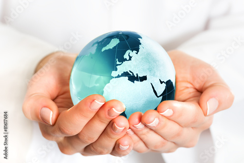 Hand holding blue earth globe
