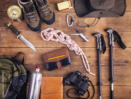 Equipment for hiking on a wooden floor background