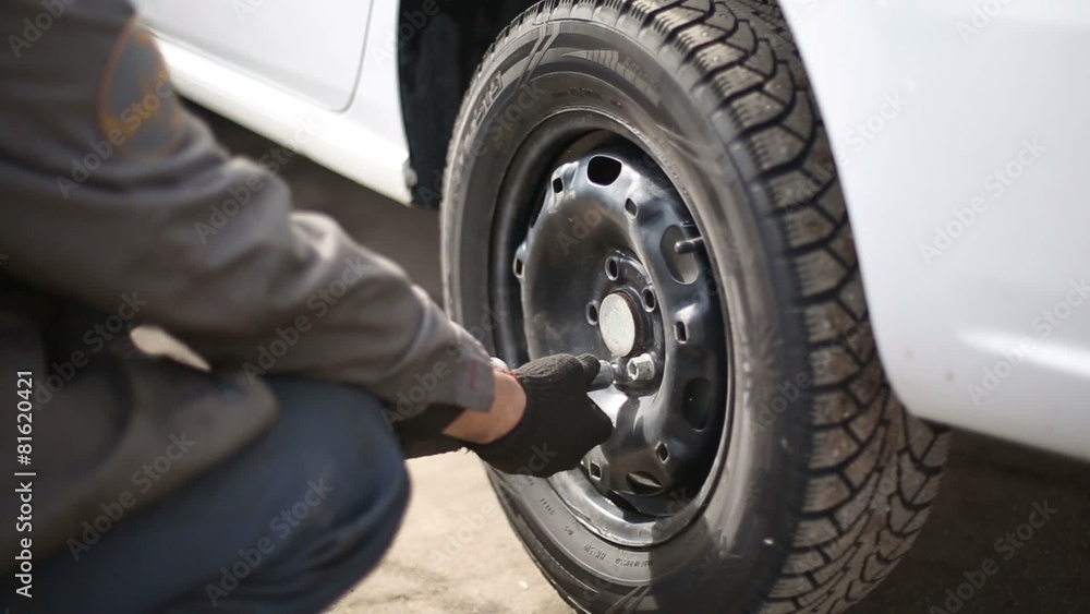 Replacement car tire at the service station Replacement car tire at the service station