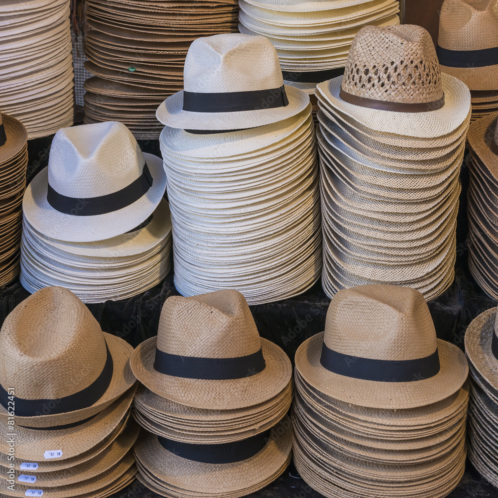 Trilby hats and straw hats on display on a stall or shop
