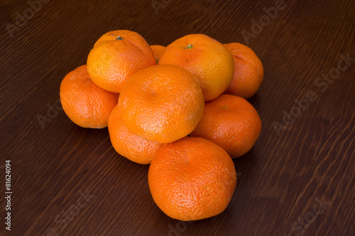 fresh bunch of mandarines in a wooden background