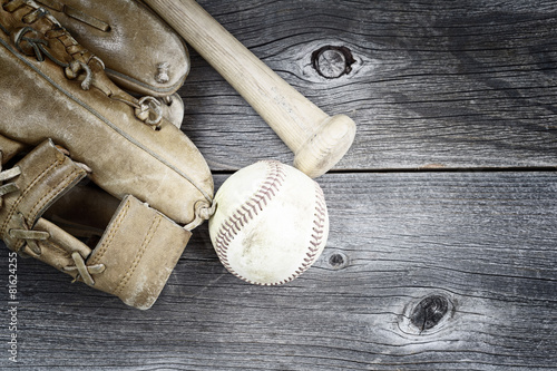 Used Baseball equipment on rustic wood