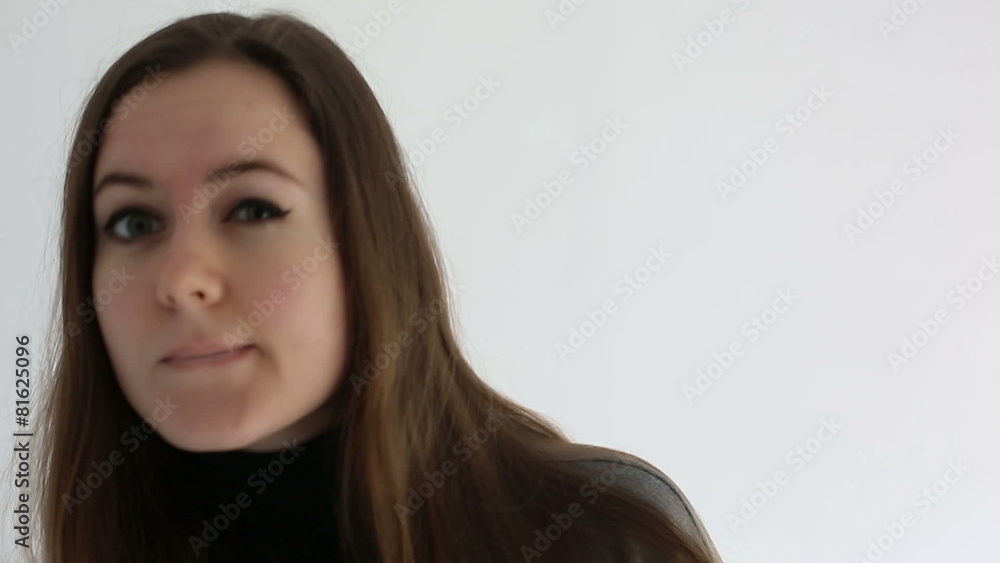 Woman flirts looking at camera white studio background Woman flirts looking at camera white studio background
